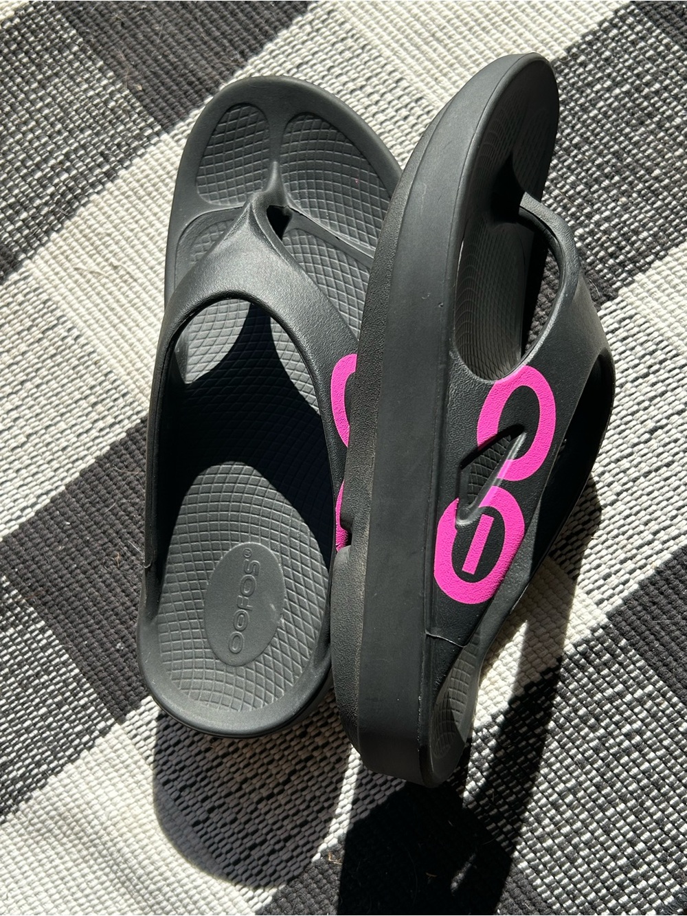 OOFOS Women’s Black Flip Sandals with Pink Logo